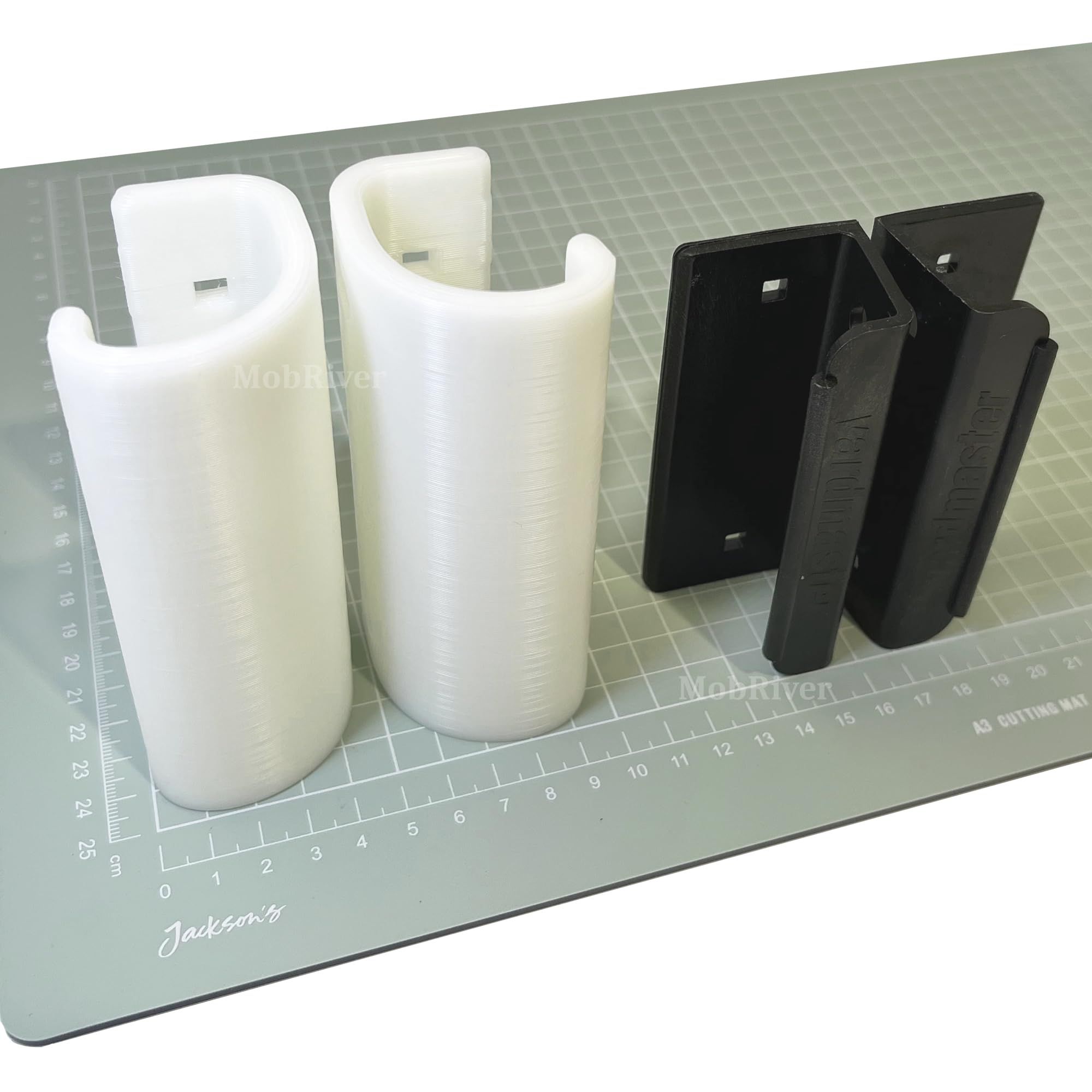 Two natural-colour Mobriver replacement handles beside two black original Yardmaster handles